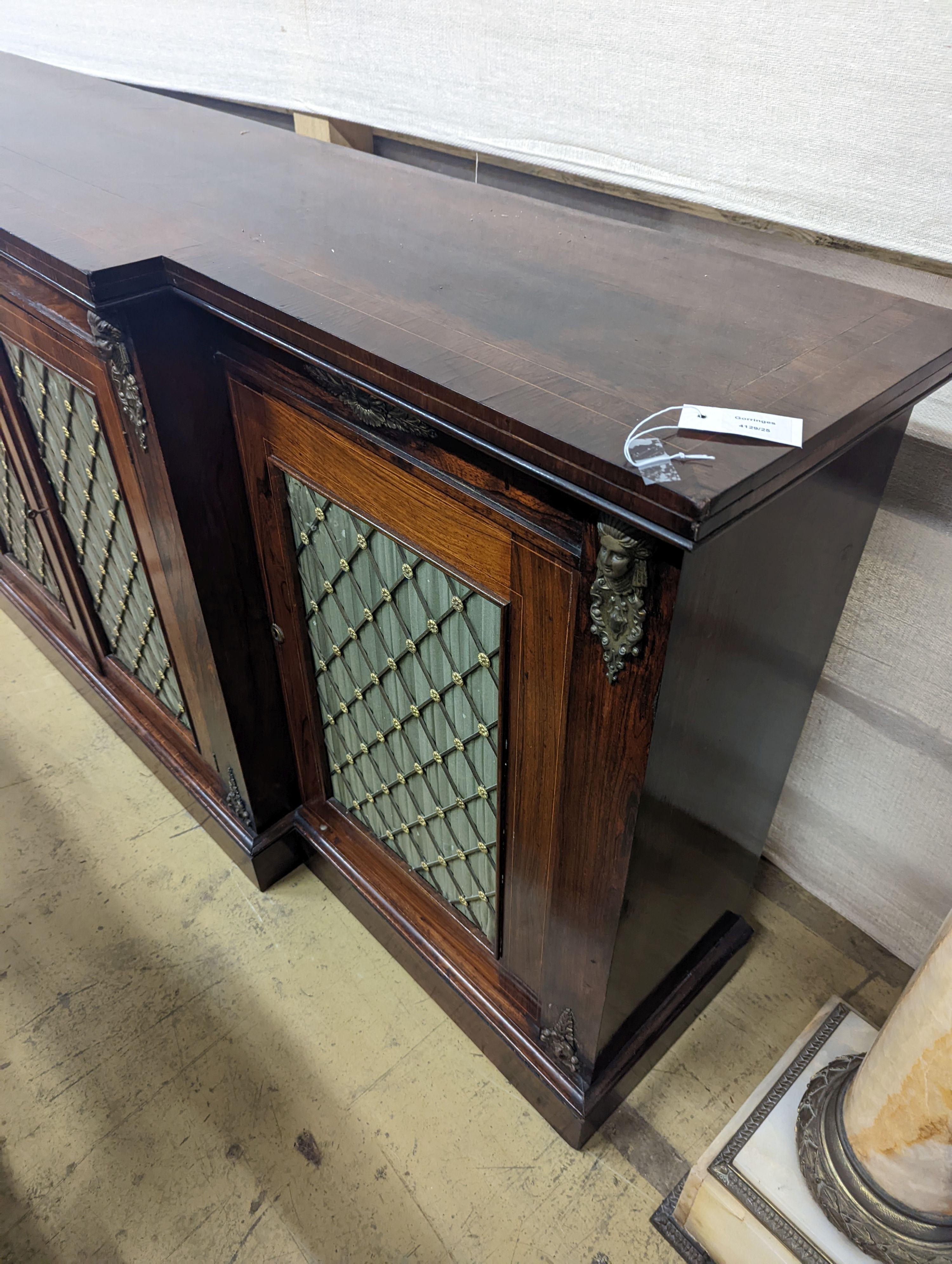 A reproduction Regency style gilt metal mounted mahogany break front dwarf cabinet, length 214cm, depth 42cm, height 91cm